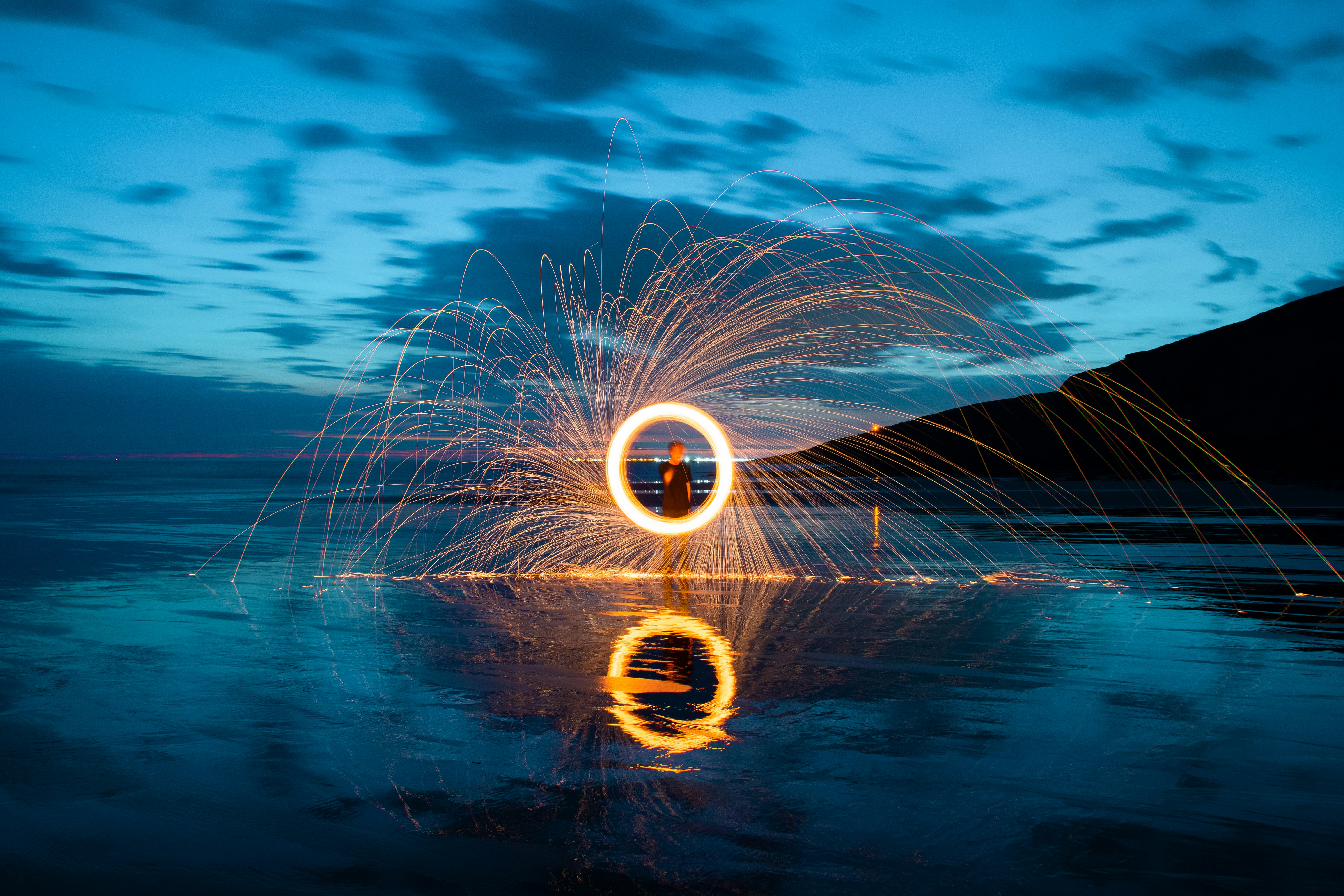 person in front of fire ring during nighttime